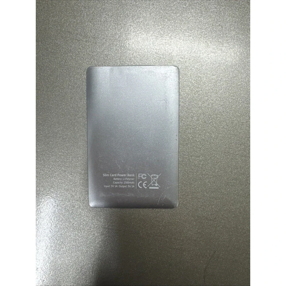 Ultra Slim portable charger silver with looks like Micro-USB cord see photos